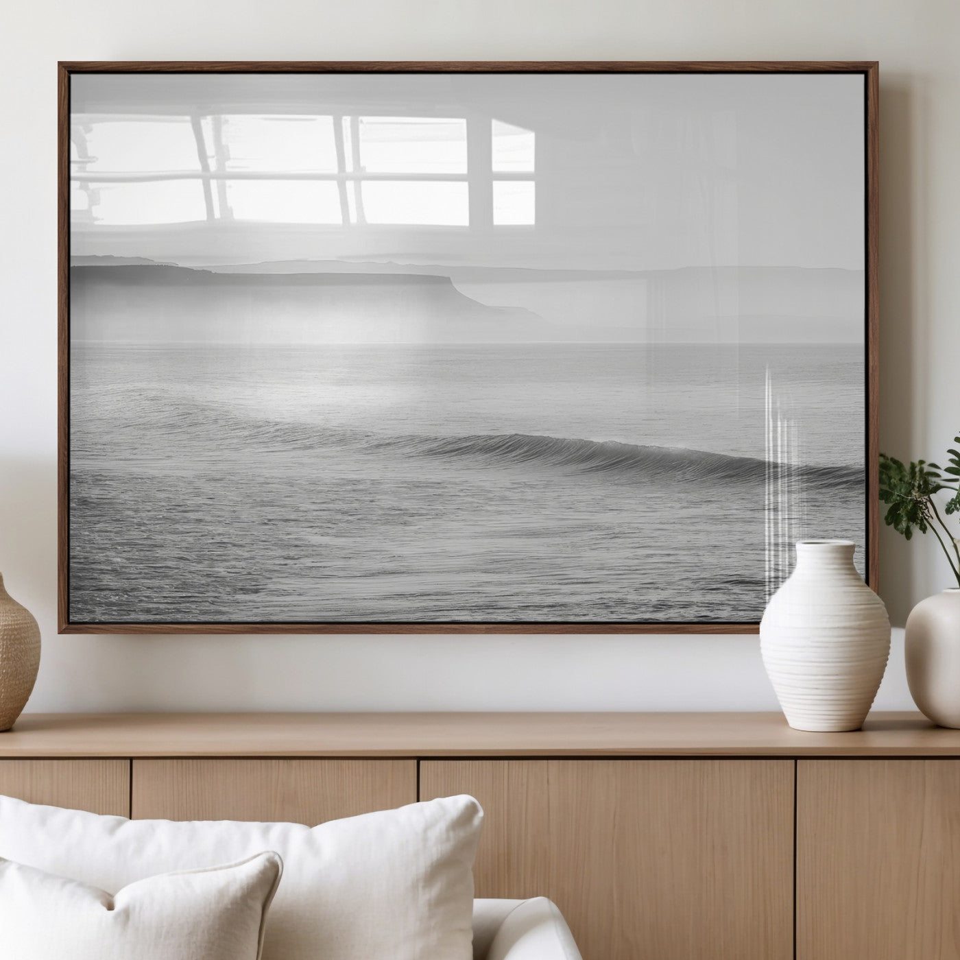 A black and white minimalist seascape featuring soft rolling waves and misty distant cliffs, creating a serene and timeless coastal atmosphere.