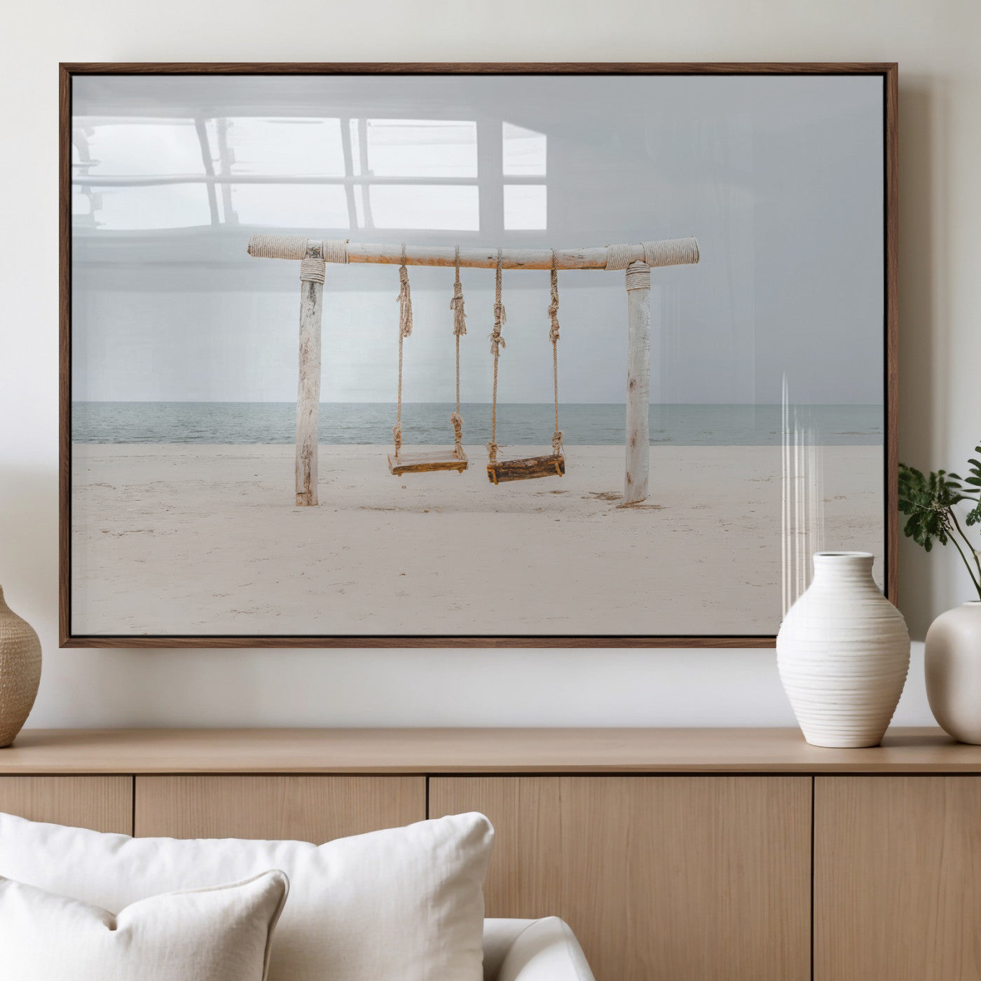 A rustic wooden beach swing stands on a serene sandy shore with an ocean horizon in the background, creating a tranquil and dreamy coastal escape.