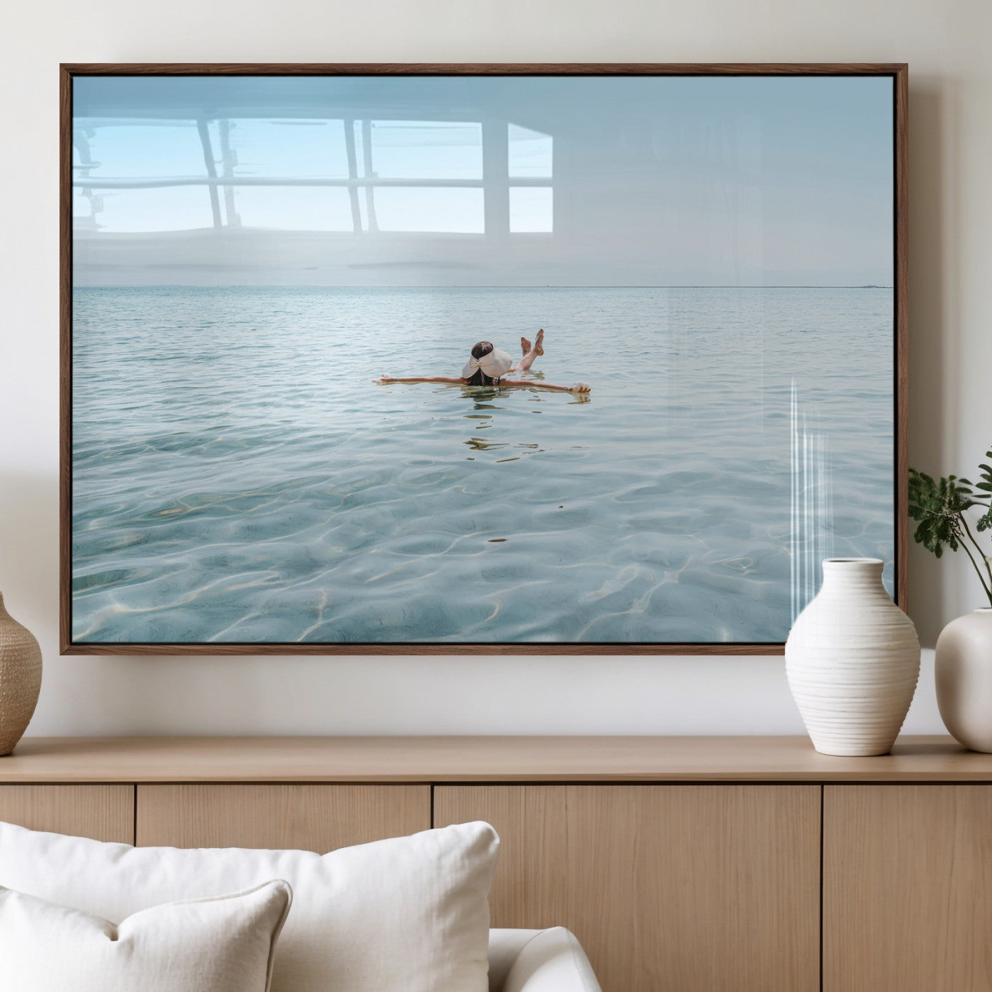 A peaceful minimalist scene of a person floating on crystal-clear water, surrounded by a vast open horizon, capturing relaxation and serenity in a tranquil aquatic setting.