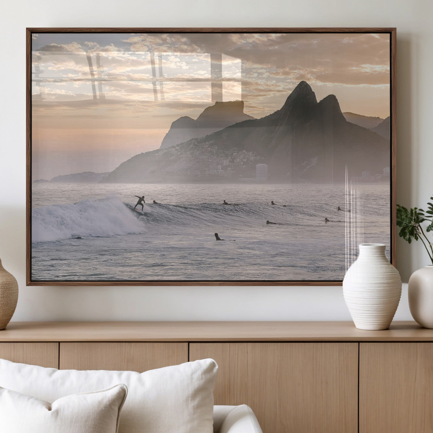 A surfer rides a golden hour wave near misty coastal mountains, surrounded by fellow surfers, capturing the spirit of a coastal adventure.