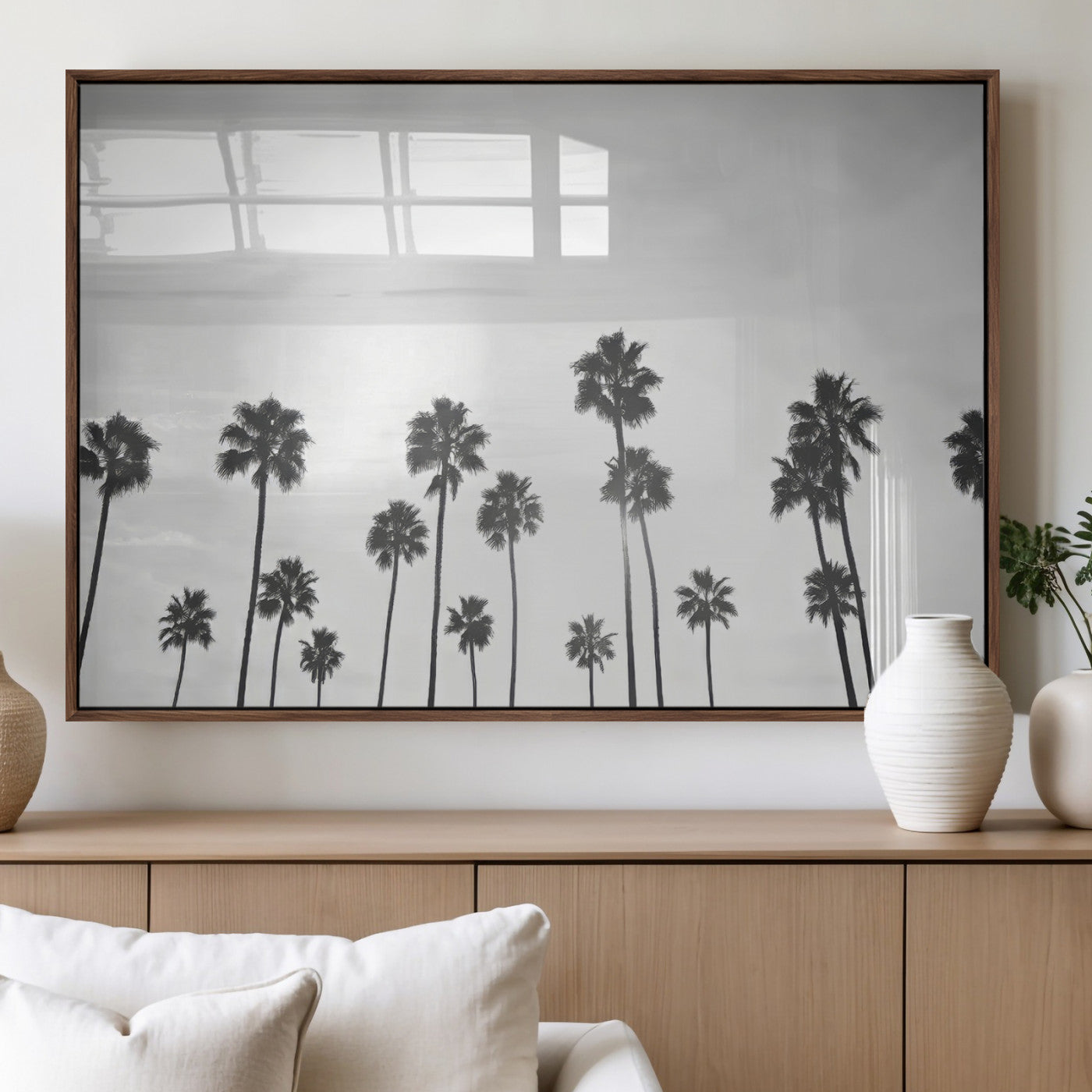 A black and white minimalist scene featuring tall palm trees silhouetted against a bright sky, creating a dreamy and timeless tropical aesthetic.