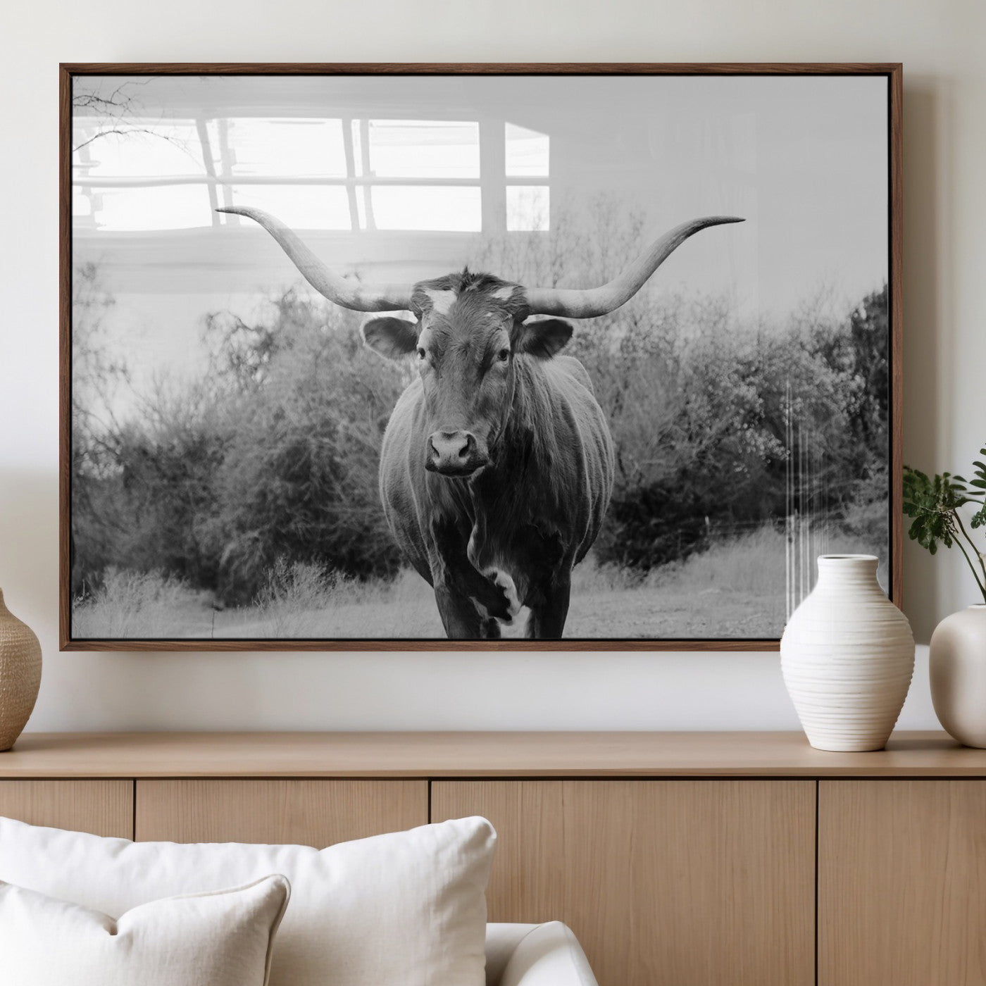 Black and white photo of a Longhorn cow facing camera, ideal for rustic, farmhouse, or western-themed home wall decor.