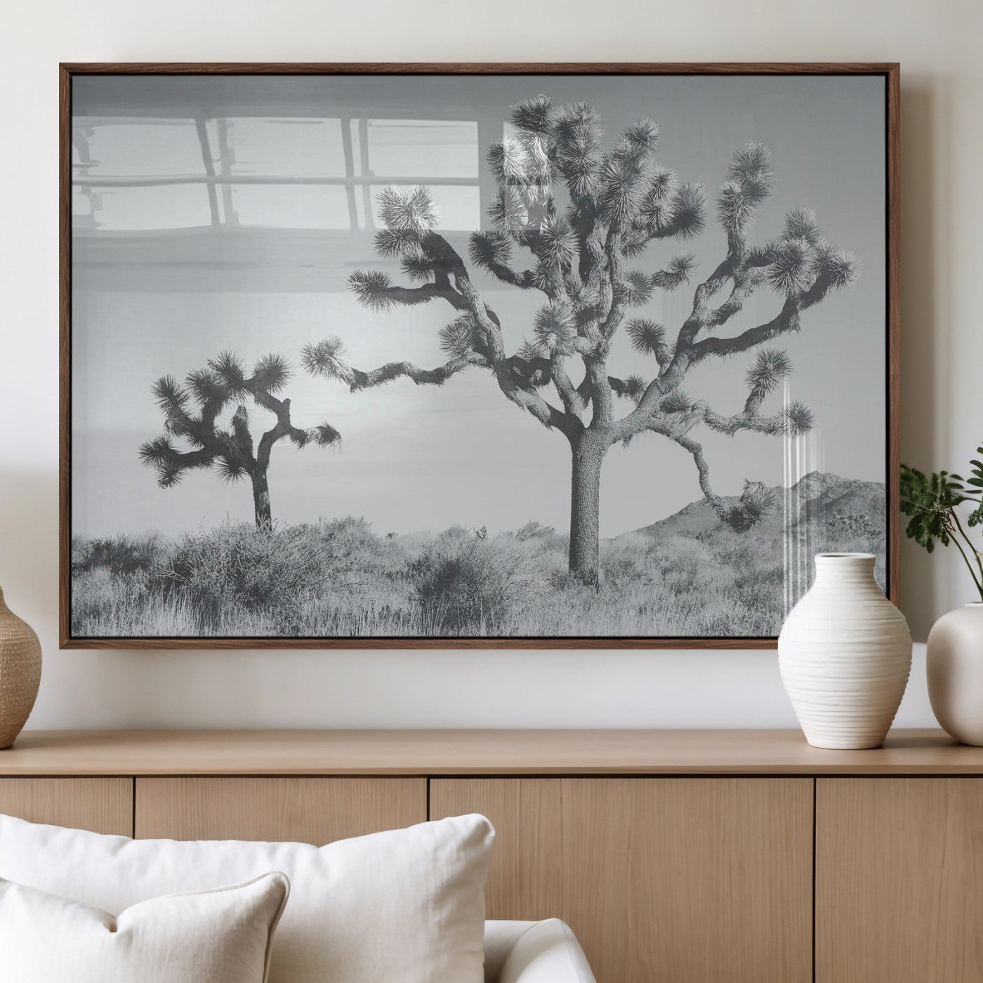 Two Joshua trees in a black and white desert landscape with distant hills, ideal for boho or rustic interior wall styling.