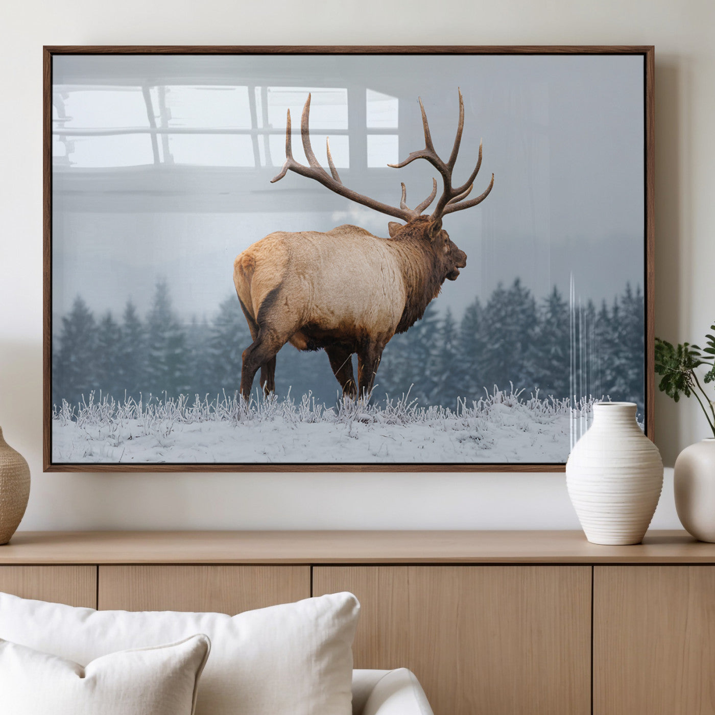 Large elk standing in a snowy field with pine trees in the background, ideal for rustic cabin or lodge-style wall decor.