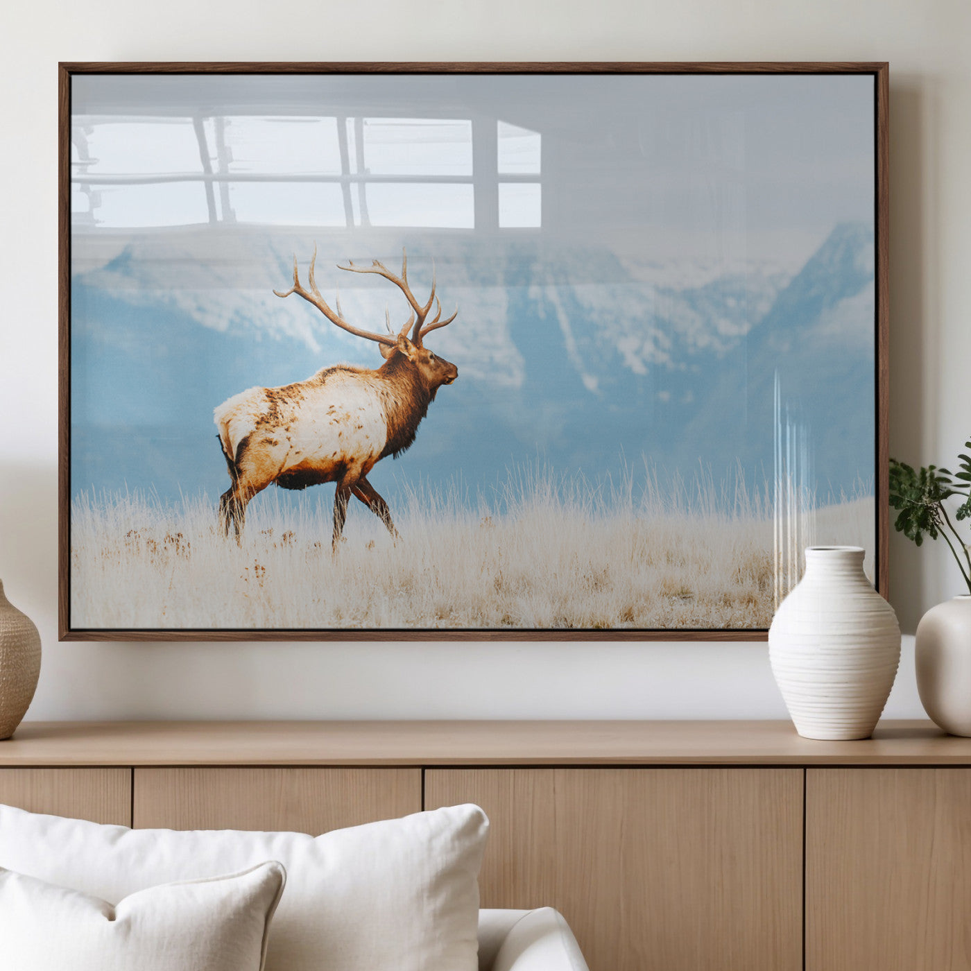 Majestic elk standing on dry grassland with snowy mountains in the background, ideal for rustic or lodge-inspired wall decor.