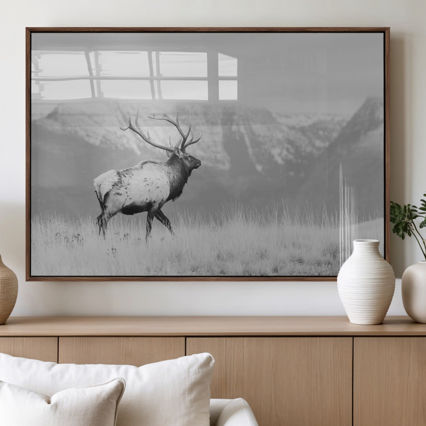 Black and white elk standing in front of snowy mountain range, perfect for rustic lodge or nature-inspired wall decor.