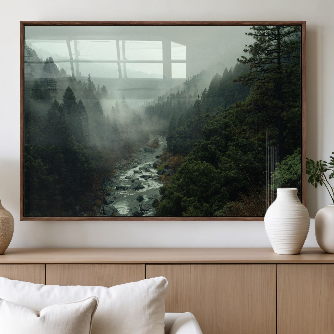 Misty forest with a winding river flowing through lush green mountains, creating a tranquil and moody wilderness landscape.