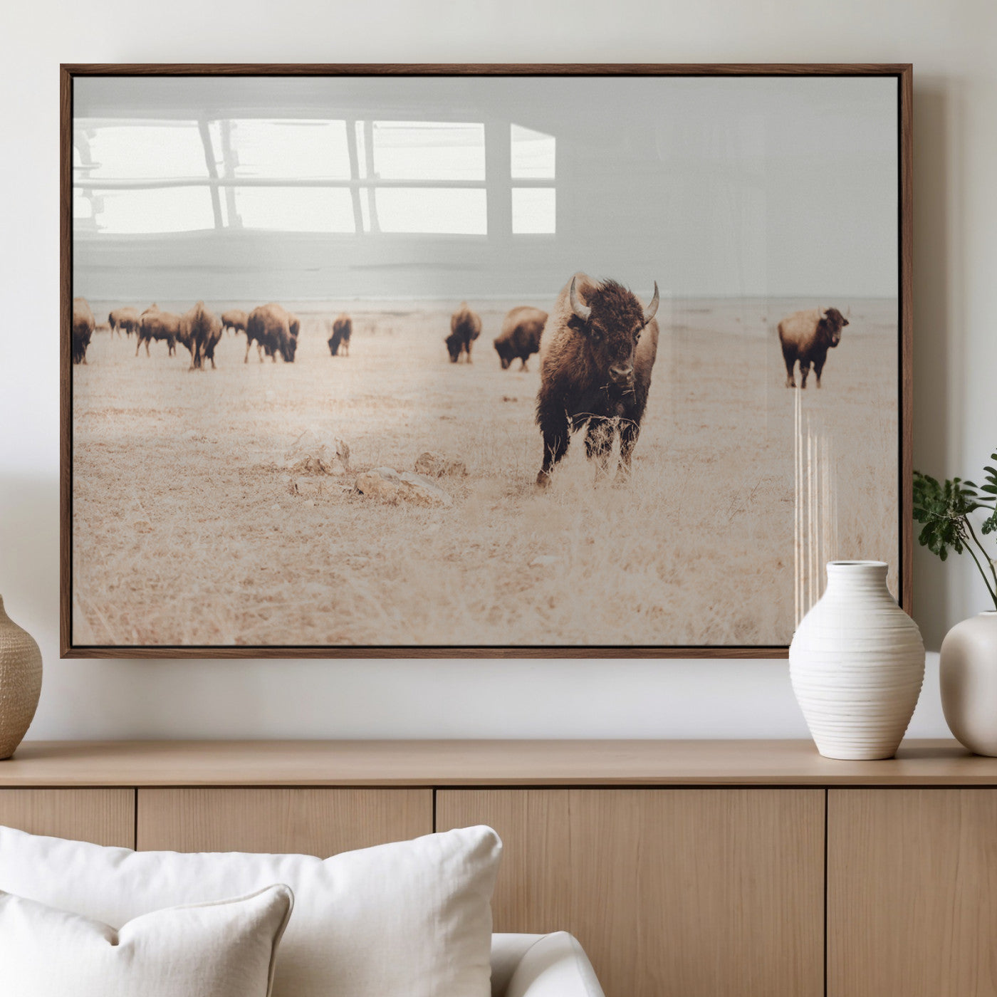 Herd of bison roaming a vast prairie with golden grass under a soft sky, creating a rustic and Western landscape, ideal for wall art.