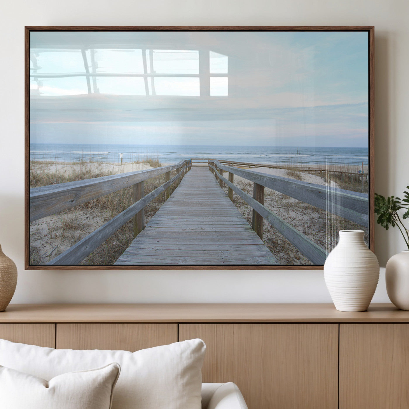 Wooden boardwalk leading to a peaceful beach with gentle ocean waves under a soft pastel sky, perfect for coastal and nautical home decor.