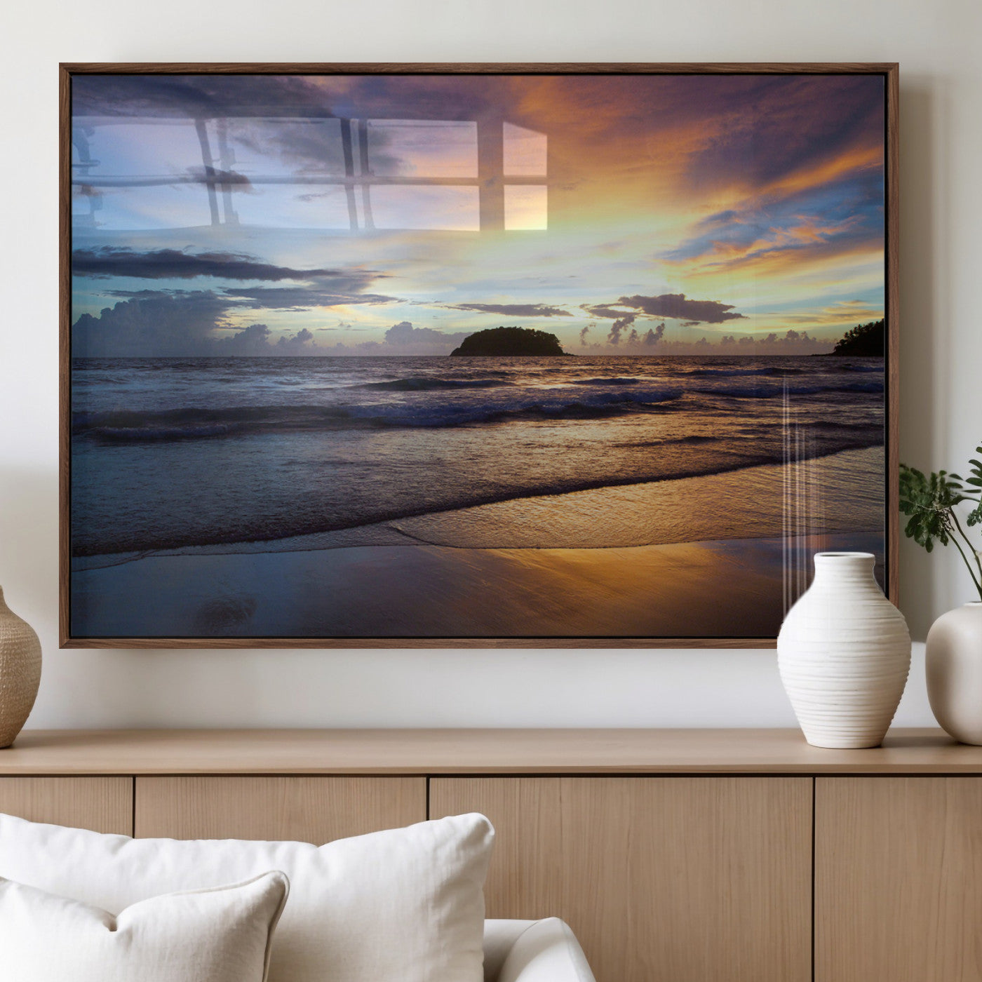 A tropical beach at sunset with waves gently washing ashore, reflecting golden and purple hues in the sky, creating a tranquil coastal scene.