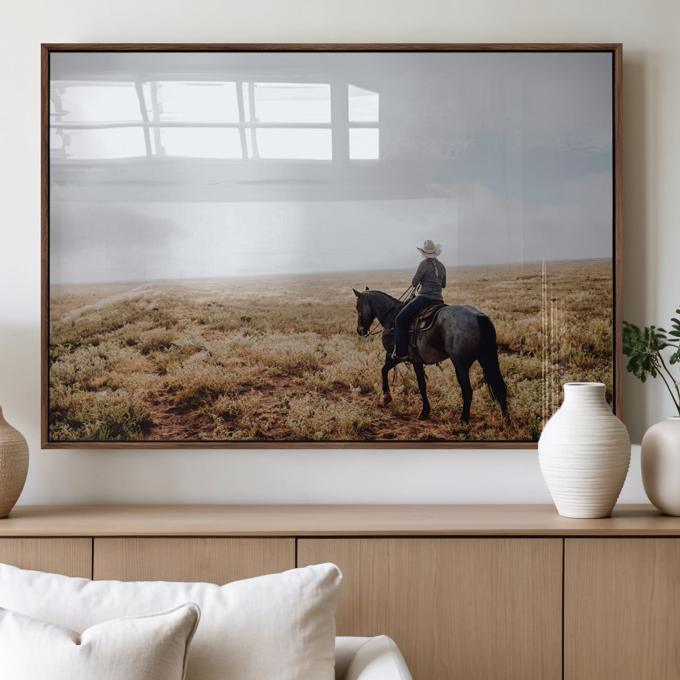 A lone cowboy riding horseback across an open prairie under a vast sky, capturing the rugged and timeless spirit of the Western frontier.