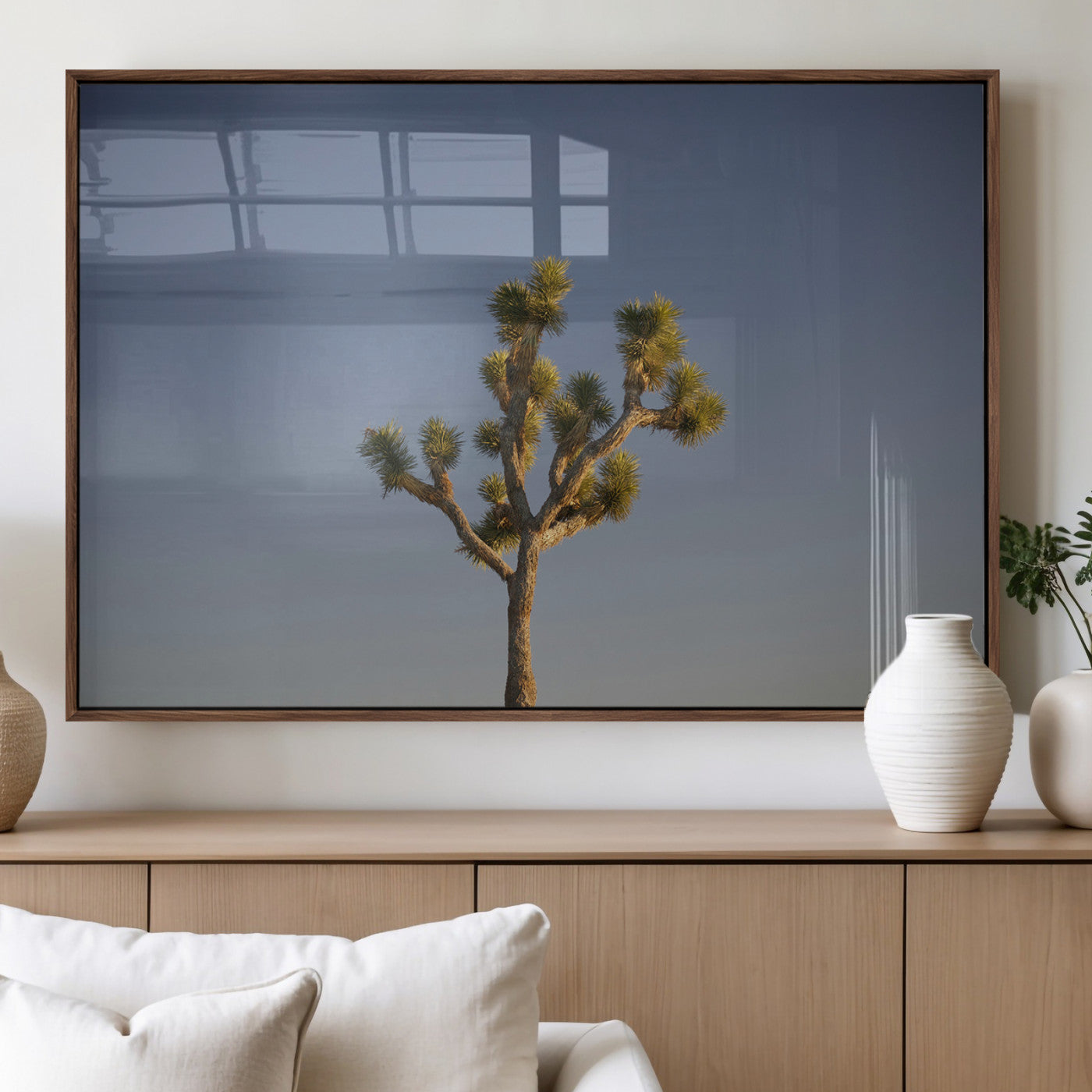 A lone Joshua Tree standing against a deep blue sky, capturing the serene and rugged beauty of the Southwestern desert landscape.