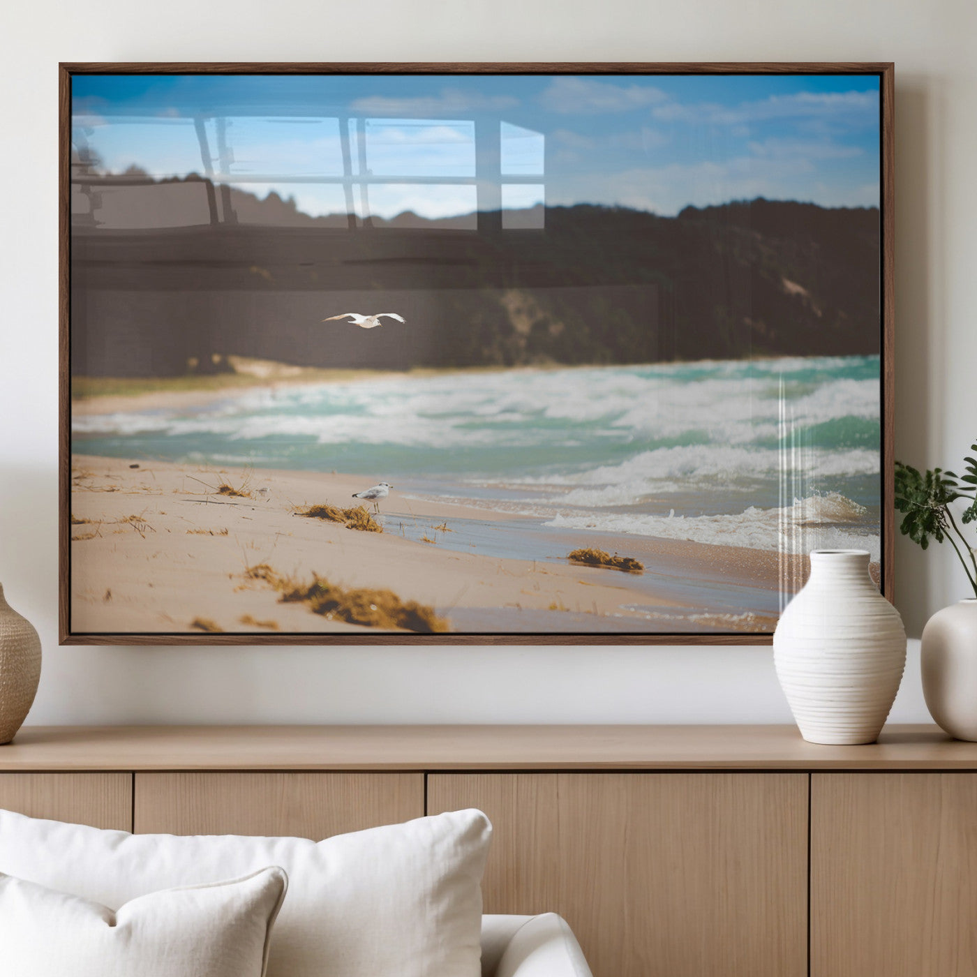 Serene beach scene with gentle ocean waves, sandy shore, and a seagull flying under a blue sky, perfect for coastal and nature-inspired decor.