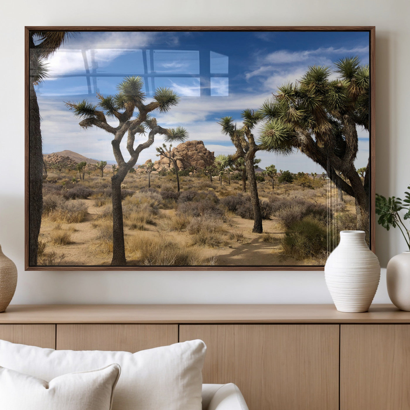 Scenic Joshua Tree landscape with rugged desert terrain, golden dry grass, and a deep blue sky, creating a warm, rustic Southwestern aesthetic.