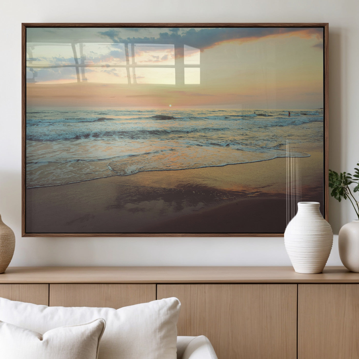 Warm sunset over gentle ocean waves with pastel sky and reflections on wet sand, creating a calm and soothing beach ambiance.