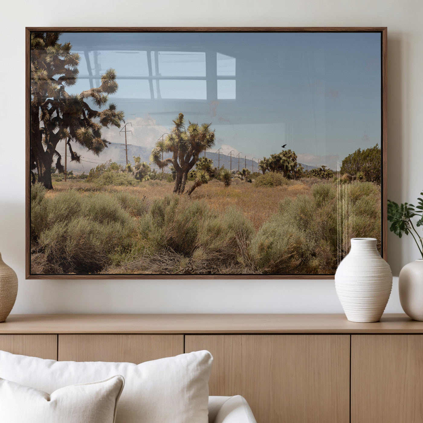 Scenic desert landscape with Joshua trees, dry grass, and distant mountains under a clear blue sky, perfect for southwestern and rustic decor.