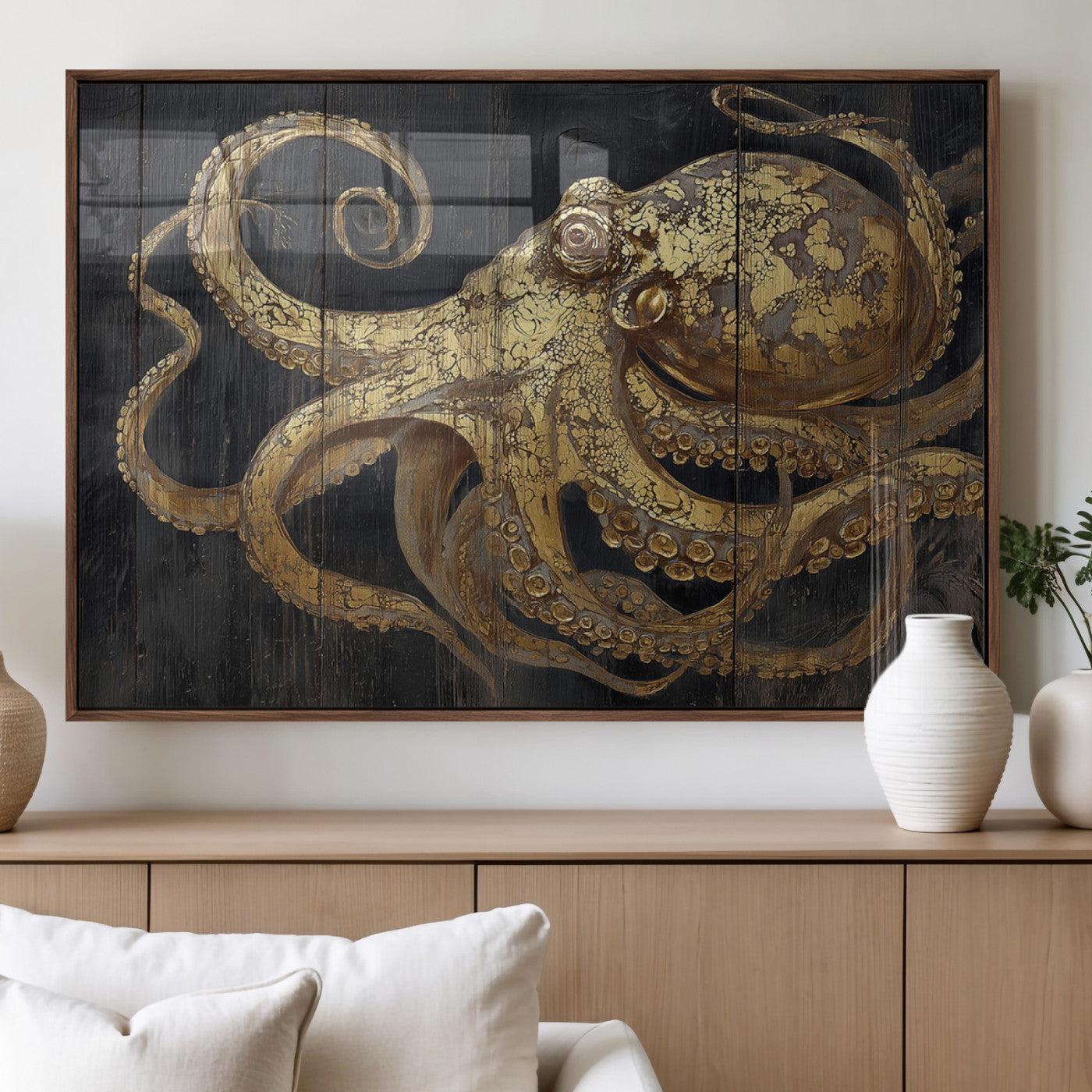 A detailed gold illustration of an octopus on black wooden planks, showing its intricate tentacles and textured skin in an artistic style.