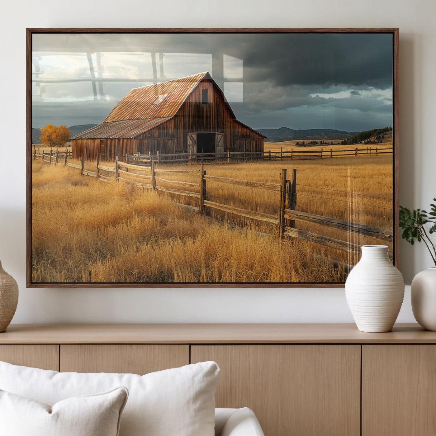 "Golden fields surrounding a rustic barn with a weathered roof, a wooden fence, and dramatic skies with sunlight breaking through the clouds."
