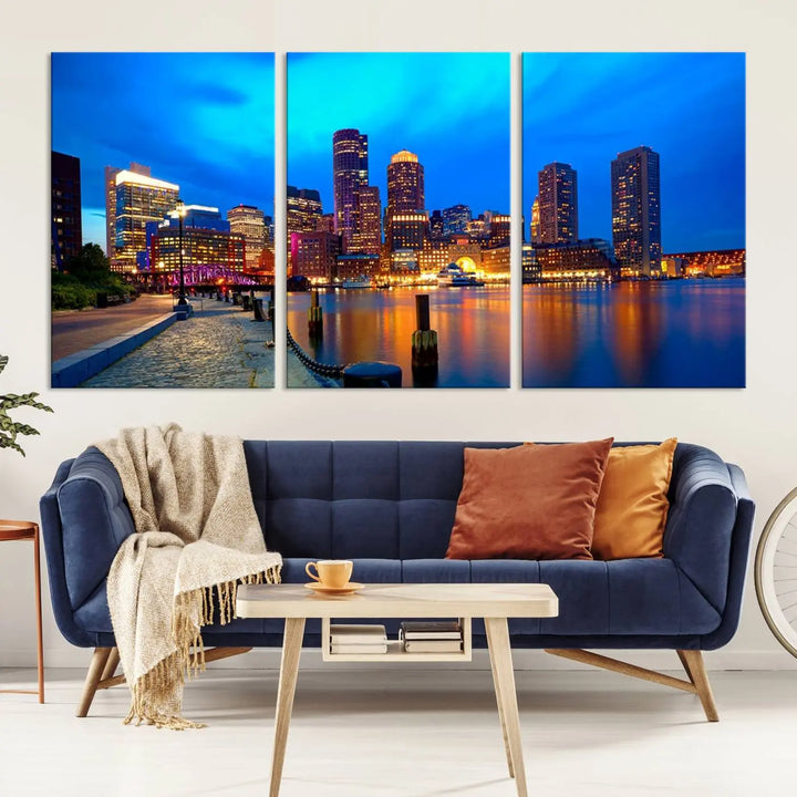 A triptych of the "Boston City Lights Night Blue Skyline Cityscape View Wall Art Canvas Print" adorns the wall. This museum-quality canvas artwork is ready to hang and includes a UV-protective coating for lasting brilliance.