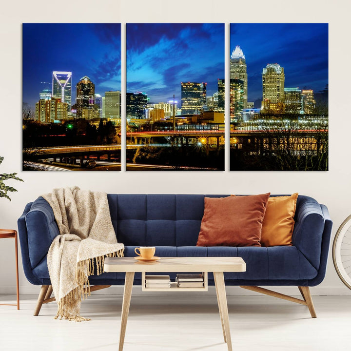 A modern living room highlighted by the "Charlotte City Lights Cloudy Blue Night Skyline Cityscape View" wall art canvas print, crafted on museum-quality canvas with UV-protective coating.