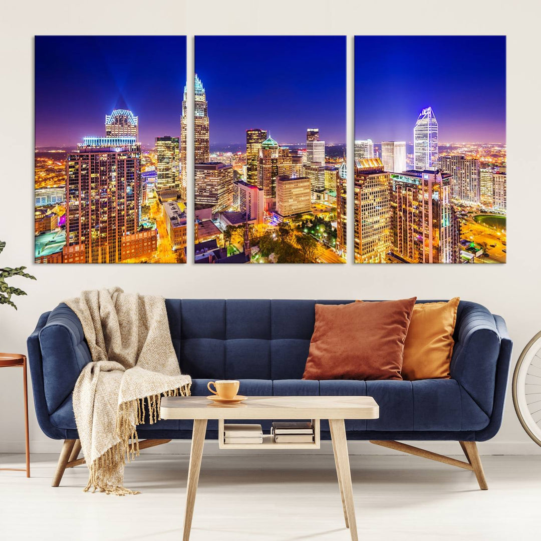 A modern living room features the Charlotte City Lights Night Blue Skyline Cityscape View wall art canvas print.