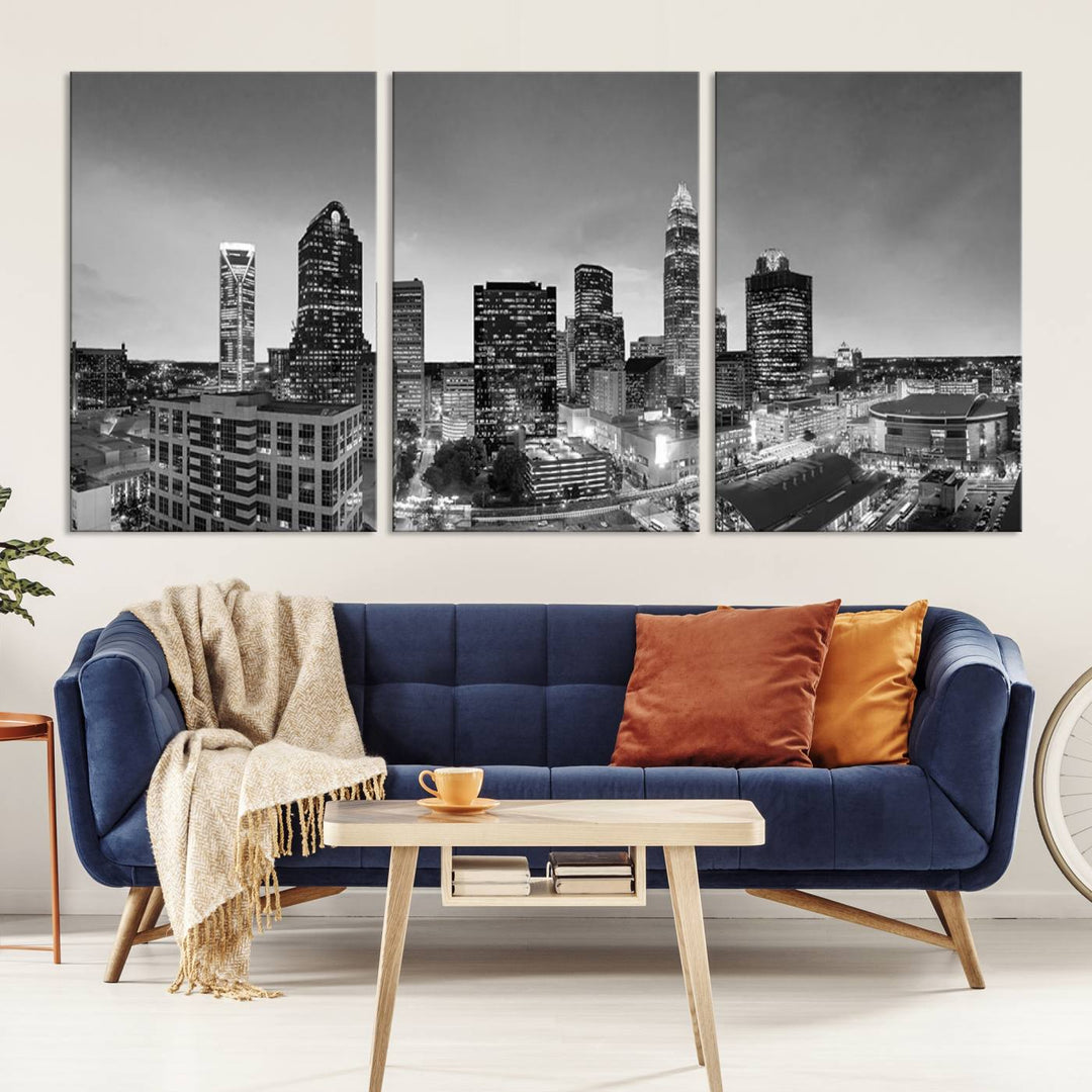 The "Charlotte City Cloudy Skyline Black and White Wall Art Cityscape Canvas Print" hangs on a dark wall, showcasing its UV-protective properties for enduring beauty.