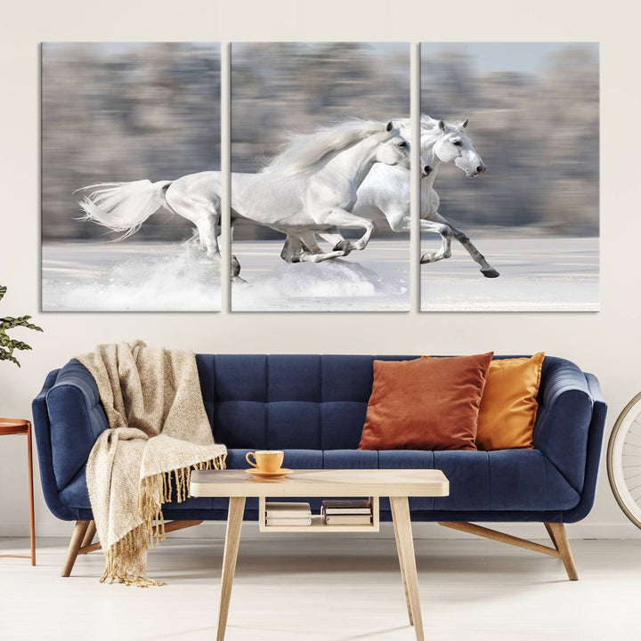 The "All The White Horses Wall Art Canvas Print" depicts a triptych of galloping white horses across a snowy landscape. These museum-quality canvases come with a UV-protective coating to maintain their stunning appearance over time.