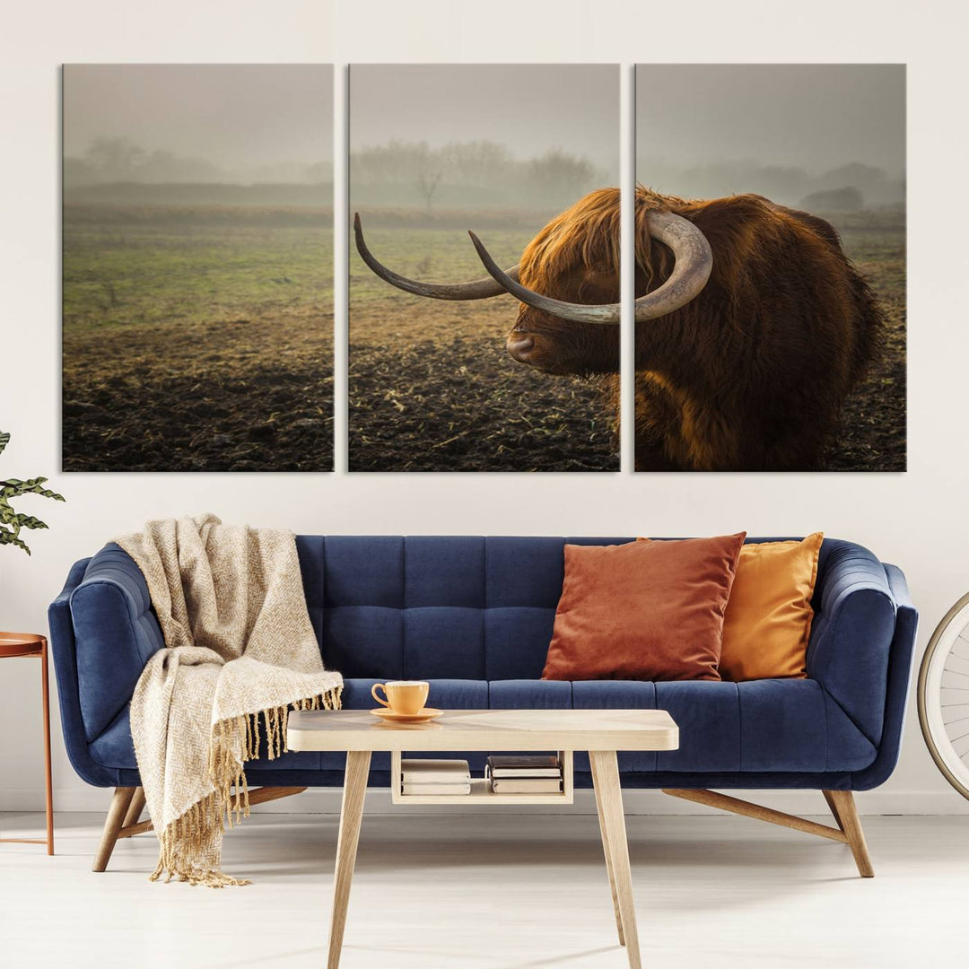 The "Big Cow Horn Wall Art Canvas Print" is a hand-assembled framed canvas depicting a Highland cow in a misty field. It is crafted with a UV-protective coating to ensure lasting vibrancy.