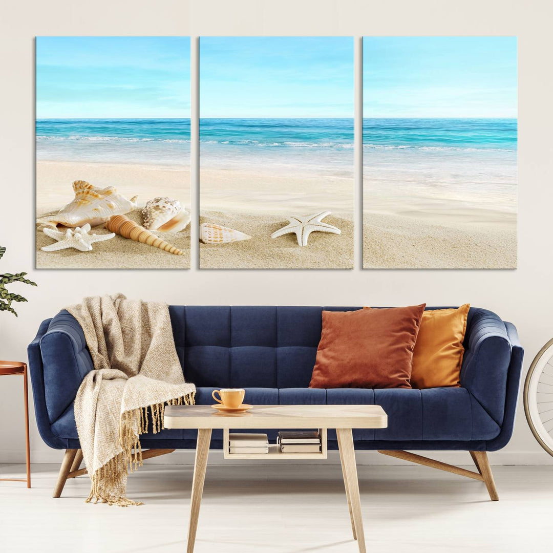 The "Turquoise Ocean View Seashell Starfish on the Beach Canvas Print Artwork" is a triptych piece that showcases a tranquil beach scene, complete with seashells and starfish adorning the sand. It is elegantly gallery-wrapped on museum-quality canvas.