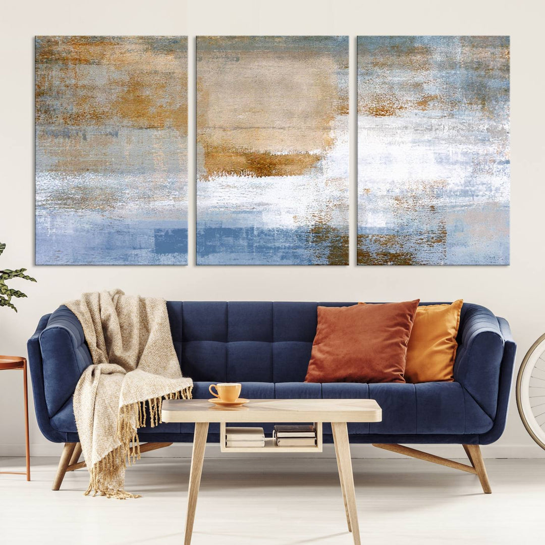 The Blue Multi Panel Abstract Wall Art Canvas Print, featuring an elegant blend of blue, beige, and brown tones, hangs gracefully on the wall, adding a contemporary touch to the space.