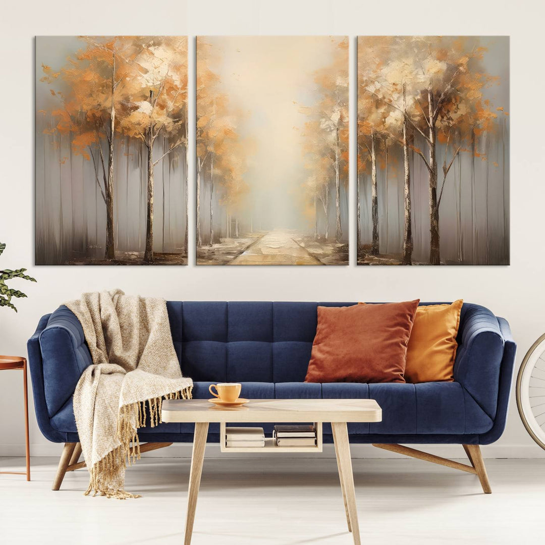 A breathtaking Autumn Forest Path Wall Art, a large canvas print perfect for the living room, bedroom, or office decor, elegantly enhances the area above a white sofa.