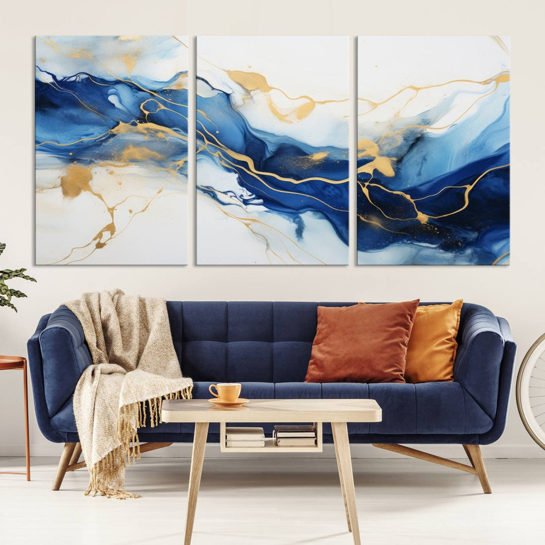 The Blue Abstract Wall Art is displayed as a triptych on museum-quality canvas, showcasing a blue and gold abstract design. The artwork includes a UV-protective coating to maintain its vibrancy and comes with the benefit of free shipping.