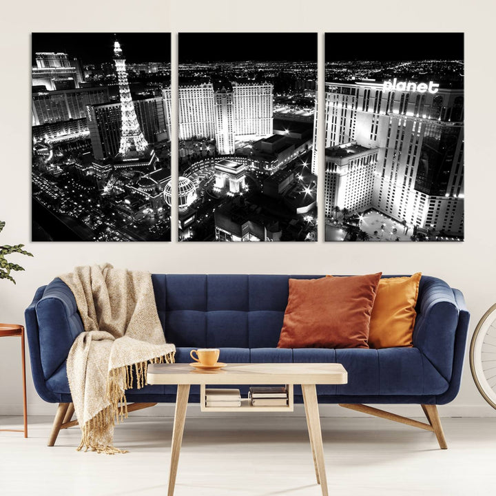 The Las Vegas Wall Art Canvas Print is a black and white triptych that showcases a city skyline at night. Crafted on museum-quality canvas with a UV-protective coating, it serves as an elegant and ready-to-hang focal point in the room.