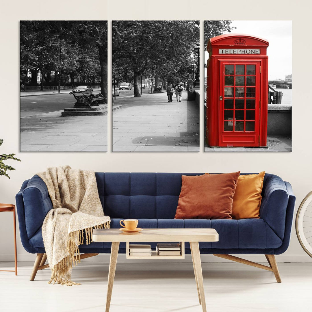 The London Phone Club Wall Art is a stunning piece that showcases a red telephone box set in a black and white street scene on museum-quality canvas. It is gallery wrapped with a UV-protective coating to preserve its vibrant charm.