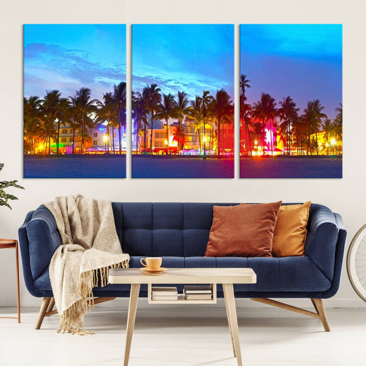 The living room features a three-panel Miami City Wall Art Canvas Print, showcasing a colorful, illuminated beach scene with palm trees on museum-quality canvas.