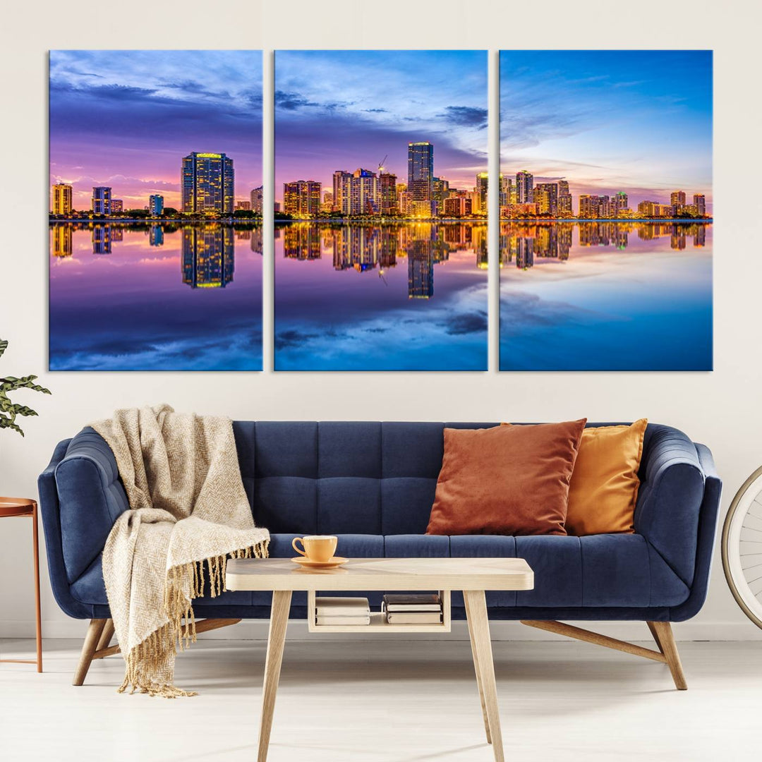 The Miami City Wall Art Canvas Print, featuring a three-panel depiction of a city skyline at sunset reflected in water, beautifully enhances the wall. Made with museum-quality canvas and a UV-protective coating, it comes ready to hang.