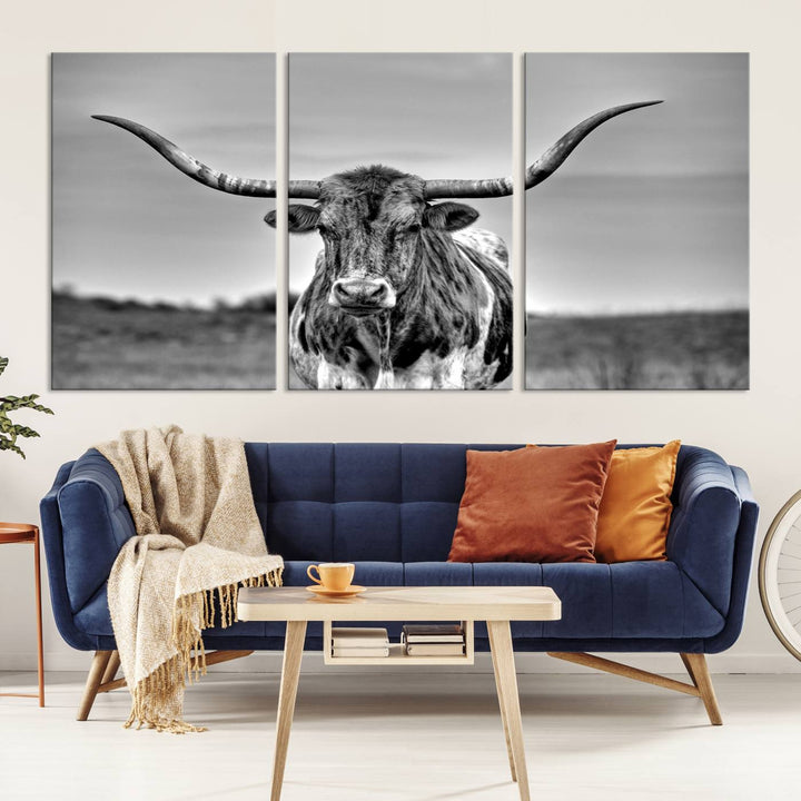 The Texas Longhorn Cow Wall Art, featuring a black and white image of a longhorn bull on canvas, brings charm to the room with its sophisticated appeal.