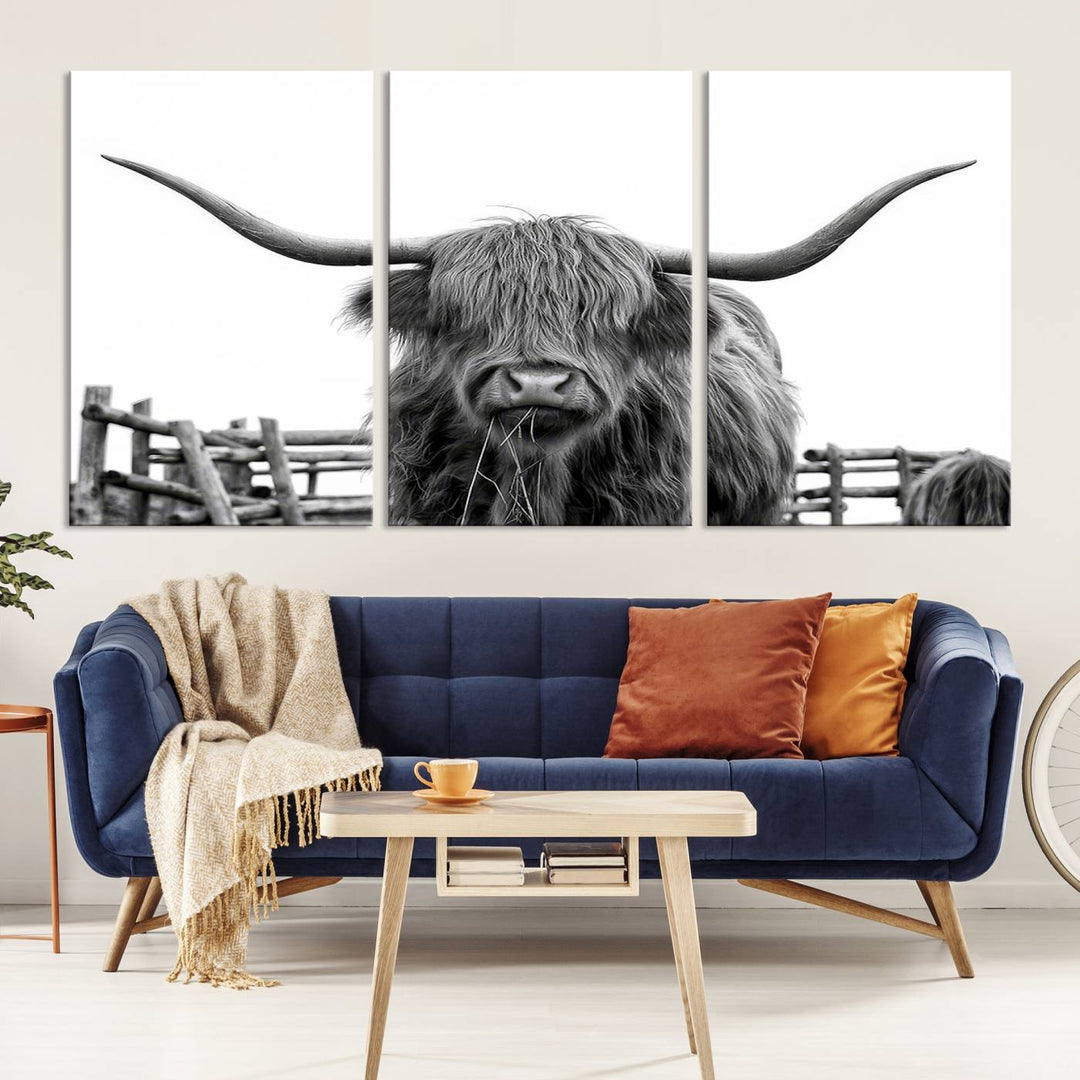 The Longhorn Canvas Print, featuring a black-and-white triptych of a Bighorn cow with shaggy fur and impressive long horns, is elegantly showcased. This wall art piece boasts a gallery-quality finish on premium canvas, bringing sophistication to any room.