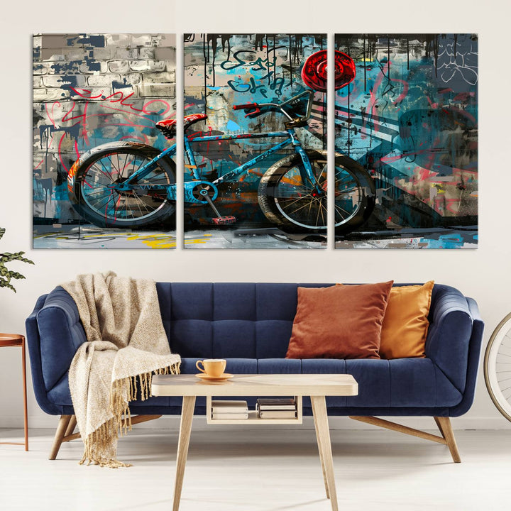 A modern living room features a triptych wall art of an abstract bicycle, designed in a graffiti style on a brick wall. This piece is expertly crafted on the Abstract Bicycle Wall Art Canvas Print, offering a premium canvas that ensures a gallery-quality finish.