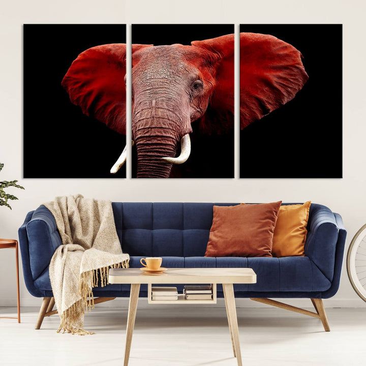 A Wall Art Canvas Print in the modern living room features a three-panel premium design of a red elephant face.