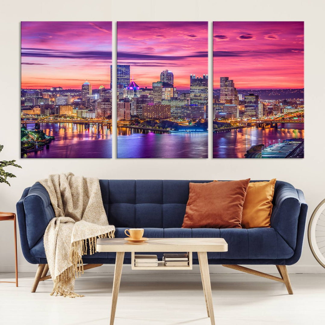 The Pittsburg Wall Art Canvas Print, showcasing a vibrant sunset glow over the city skyline and crafted by a professional artisan, adorns the space.