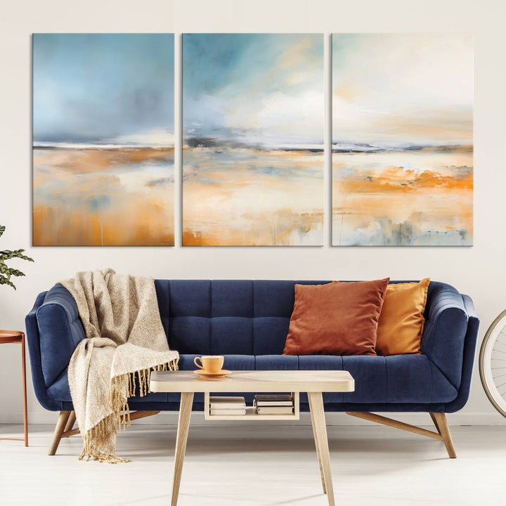 The Abstract Landscape Wall Art Canvas Print, featuring warm tones of orange and blue, is displayed on a dark wall.