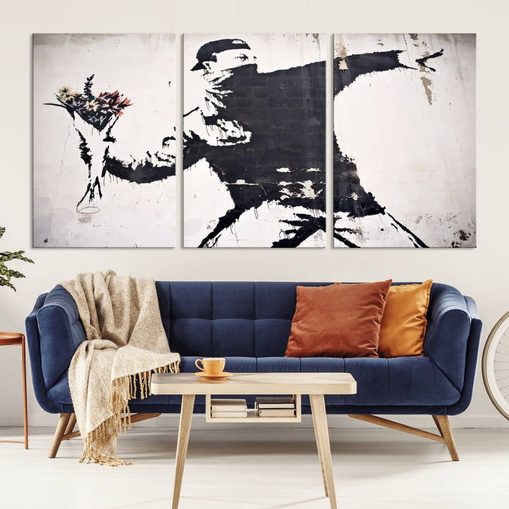 The living room features a split-panel art piece named "Banksy Flower Throw Graffiti Street Wall Art Canvas Print," gallery wrapped on museum-quality polycotton canvas and accentuated by modern decor elements.