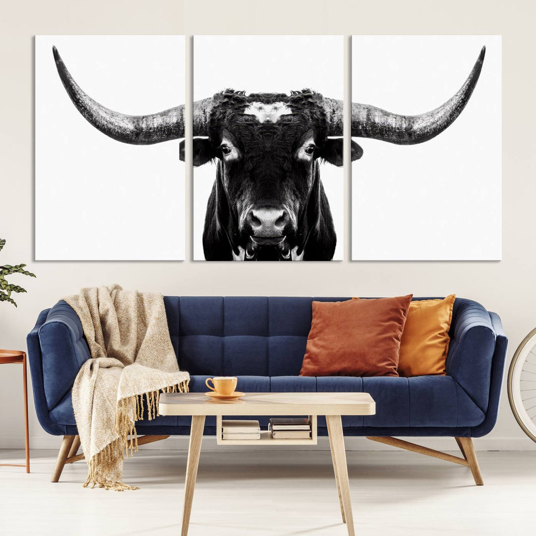 The living room is adorned with the Texas Cow Longhorn Wall Art Canvas Print in Black and White—framed and ready to hang.