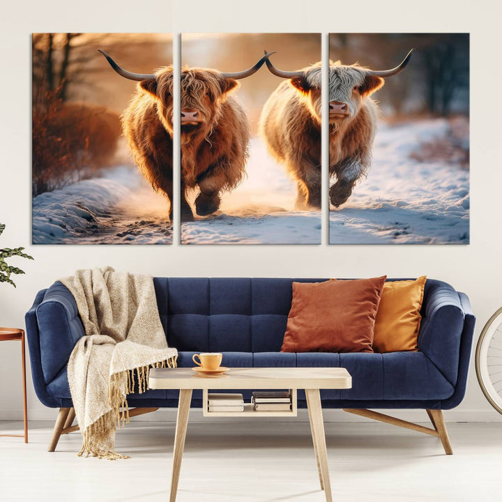 The living room showcases a triptych from the Scottish Highland Cow Horn Farm Wall Art Canvas Print collection, depicting two Highland cows running in the snow. Complementing this are handmade wall art pieces with a gallery-quality finish that add an elegant touch.