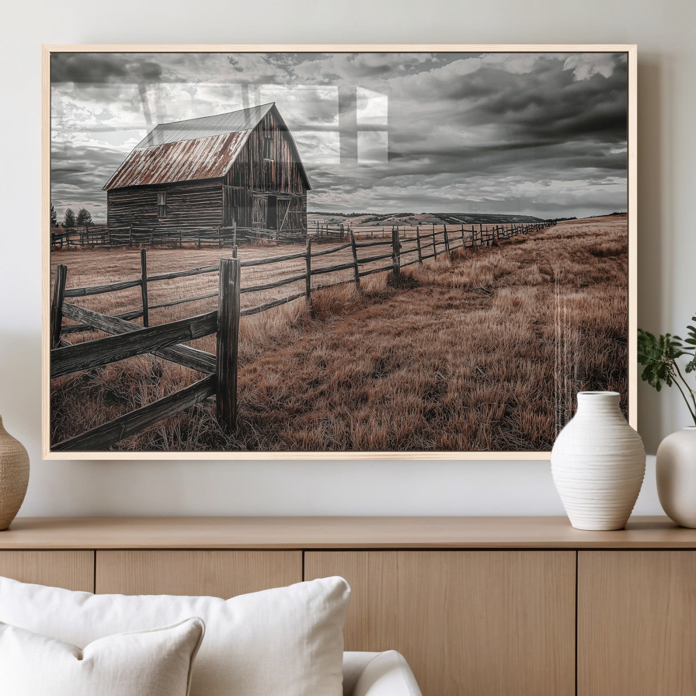Framed canvas of a rustic barn under a moody sky with weathered fence and dark fields, ideal for farmhouse or rural-style wall decor.