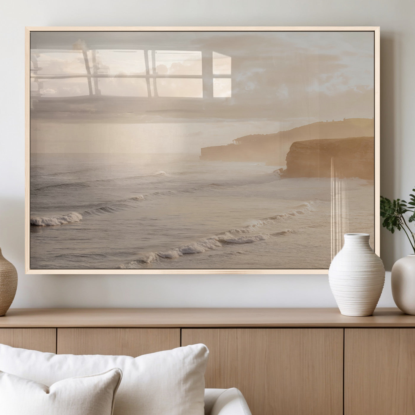 Golden hour seascape with misty cliffs and gentle waves rolling towards the shore, capturing a tranquil and warm coastal atmosphere.