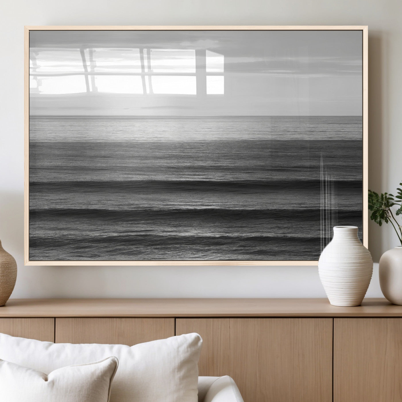 Minimalist black and white ocean view with layered waves reflecting sunlight, evoking a sense of calm and coastal serenity.