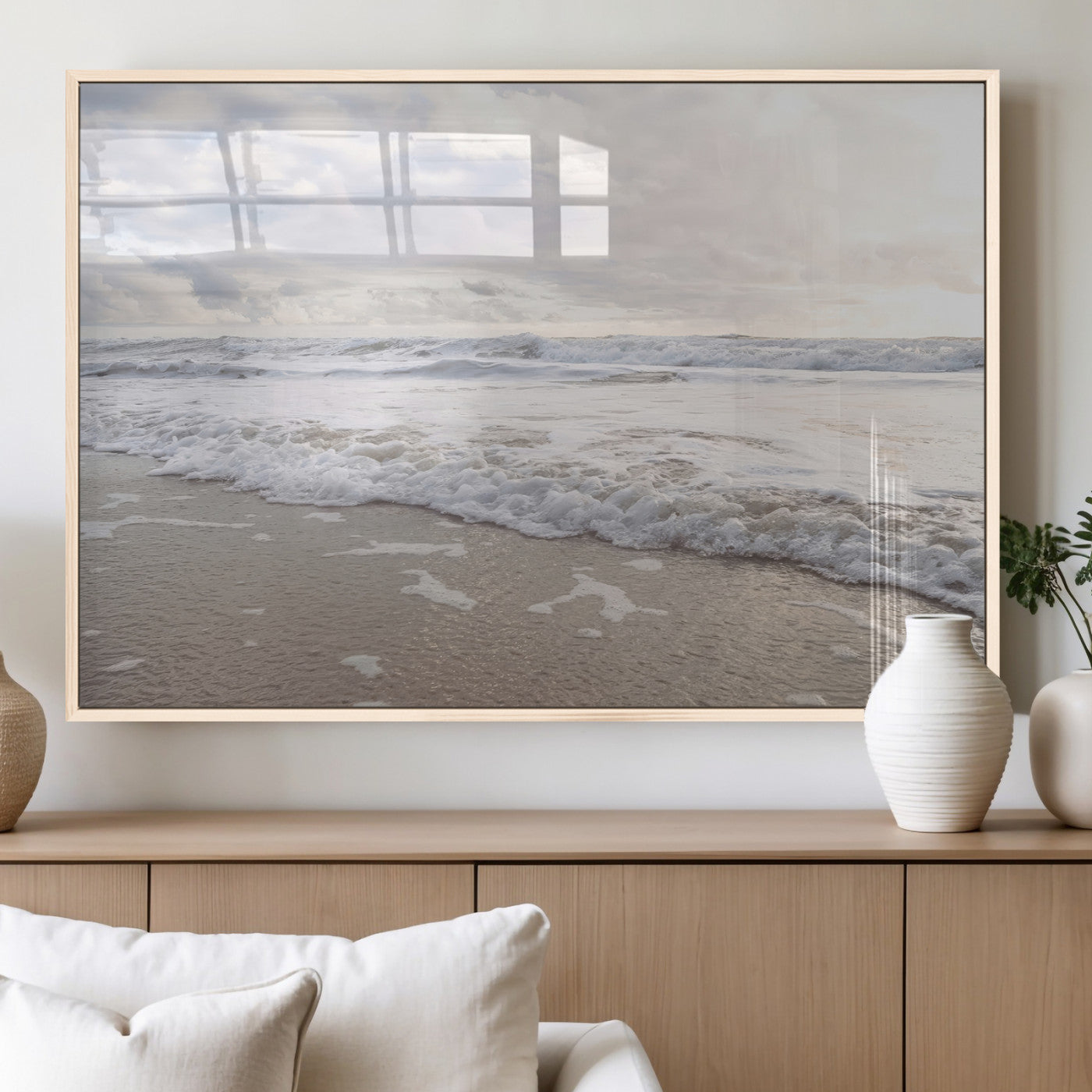 Peaceful ocean waves rolling onto the sandy shore under soft light, perfect for neutral or coastal minimalist decor themes.