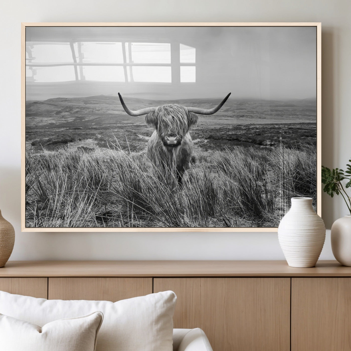 A black and white portrait of a Highland cow in a foggy Scottish countryside, capturing a rustic aesthetic and tranquil farm escape.